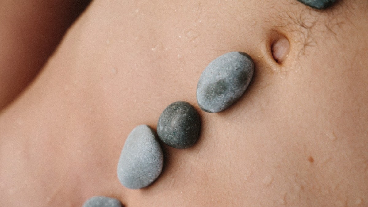 black stones on human skin